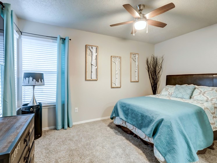 Rock Springs bedroom with large window and ceiling fan.